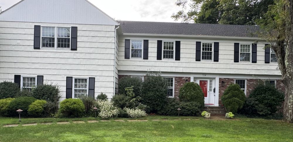 Colonial home with brick and shingle facade before renovation, Forest project