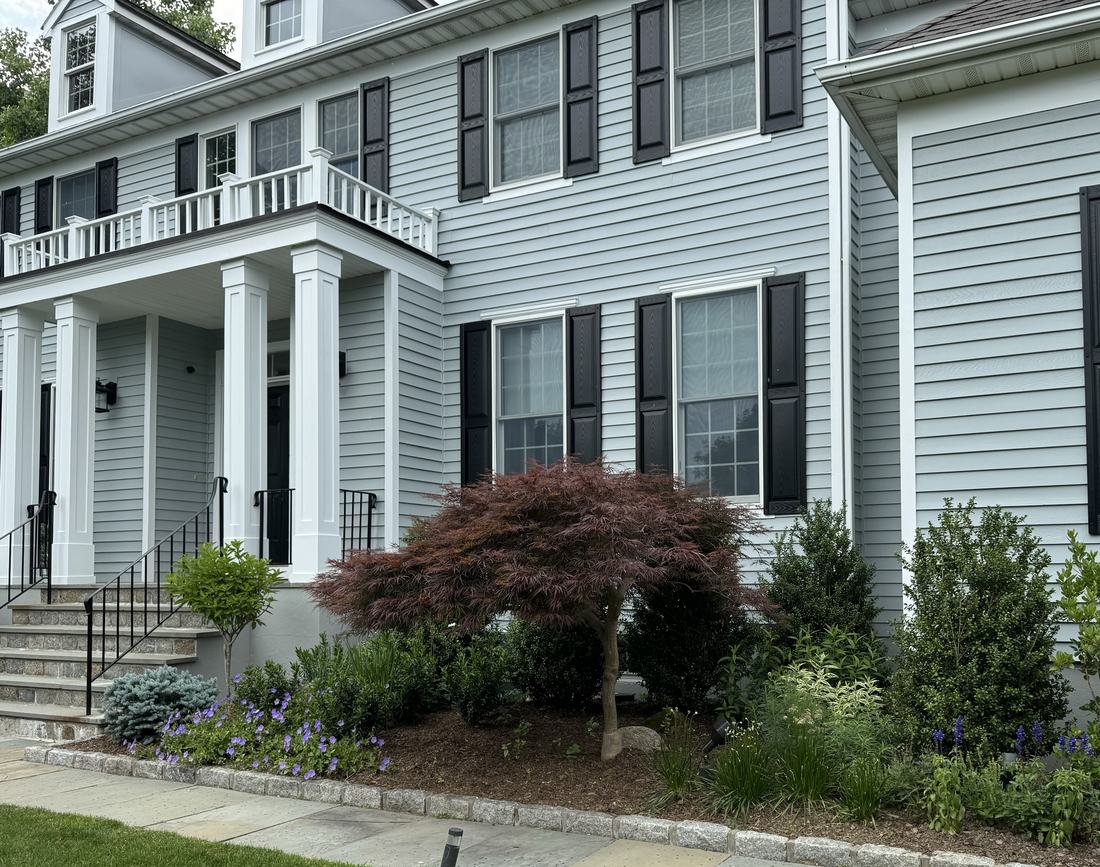 Same foundation with a Japanese maple and full mixed planting bed
